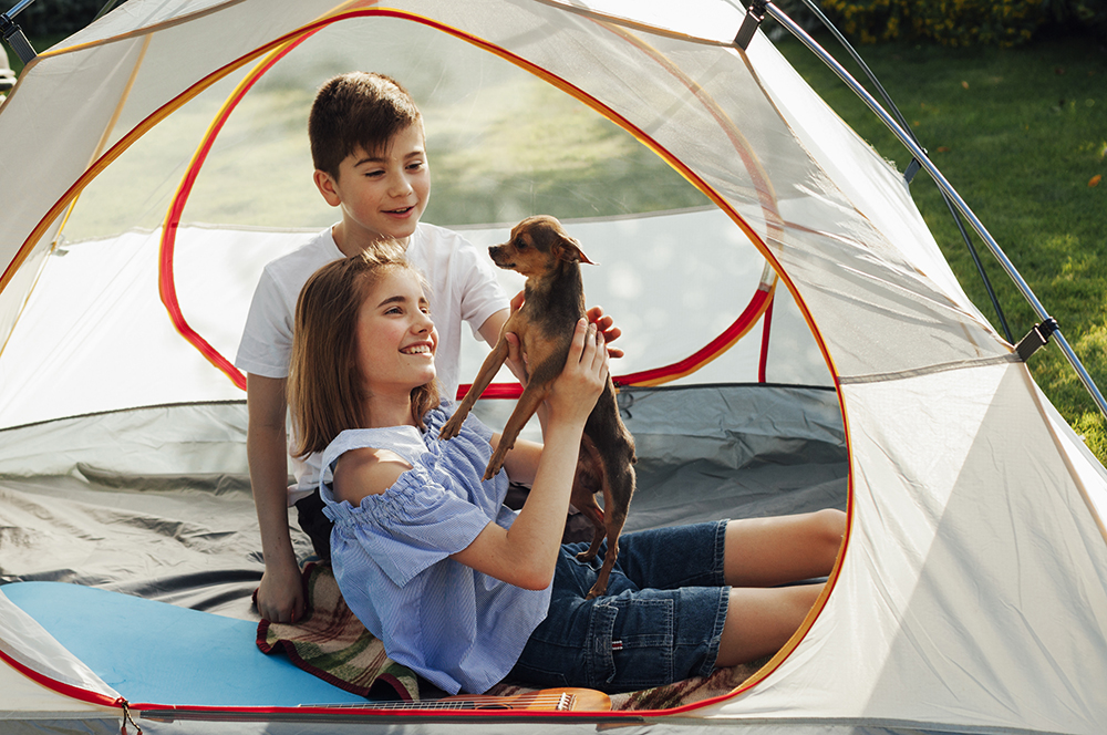 Smiling Sibling Stroking Little Dog Tent Picnic