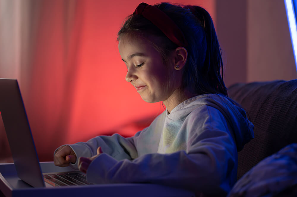 Little Girl Uses Laptop Late Night